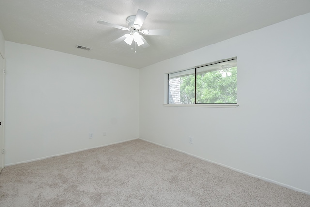 empty room with carpet flooring and ceiling fan