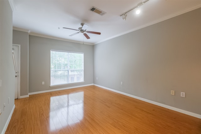 spare room featuring ornamental molding, light hardwood / wood-style floors, ceiling fan, and track lighting