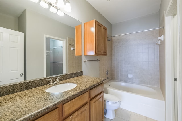 full bathroom with tiled shower / bath combo, large vanity, tile floors, and toilet