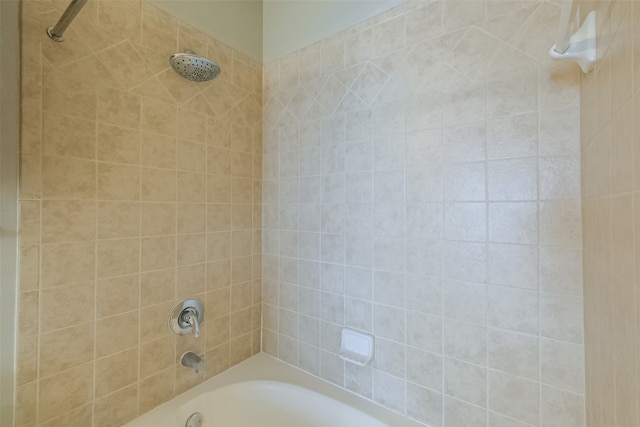 interior space featuring tiled shower / bath combo