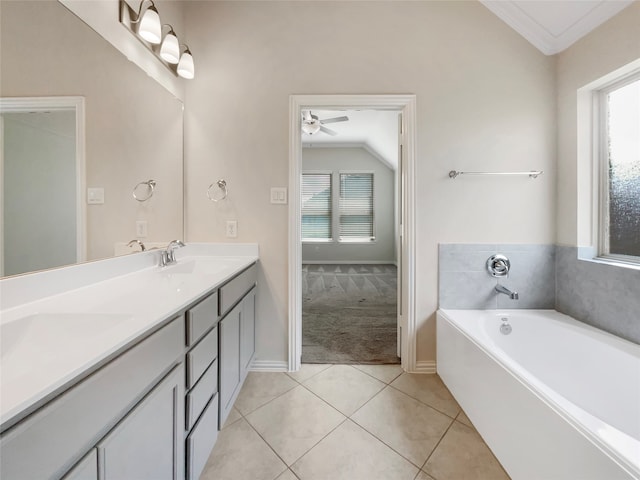 bathroom with dual bowl vanity, ceiling fan, vaulted ceiling, a bathing tub, and tile flooring