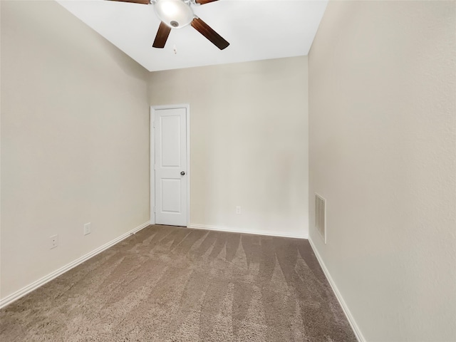 carpeted spare room featuring ceiling fan