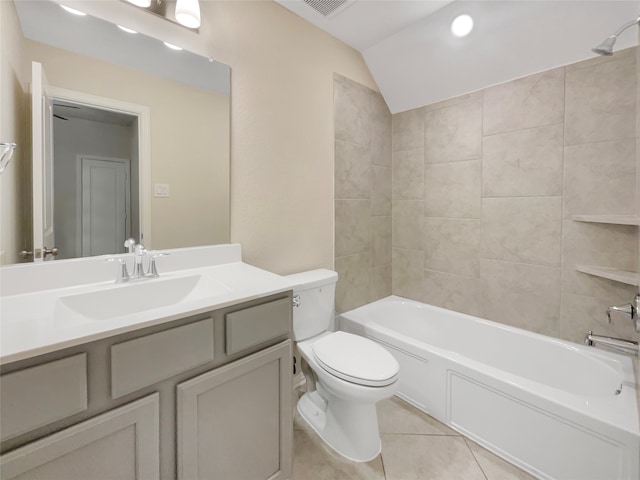 full bathroom featuring tiled shower / bath combo, tile floors, vanity, toilet, and lofted ceiling