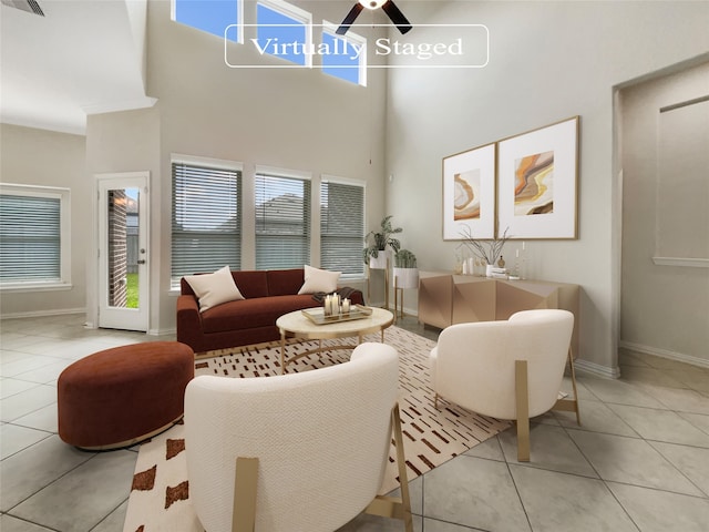 tiled living room featuring a healthy amount of sunlight, ceiling fan, and a high ceiling