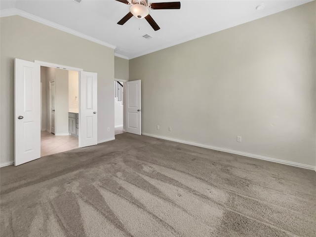 unfurnished bedroom featuring ensuite bath, ceiling fan, crown molding, and light tile flooring