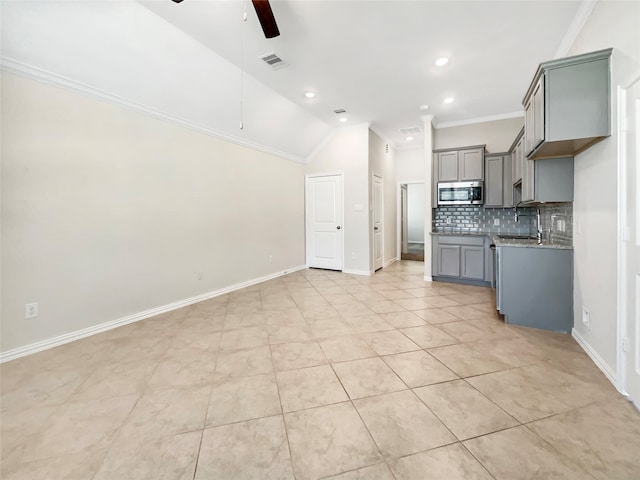 kitchen with ornamental molding, lofted ceiling, ceiling fan, and tasteful backsplash