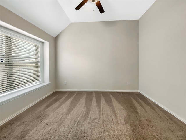 carpeted spare room featuring ceiling fan and lofted ceiling