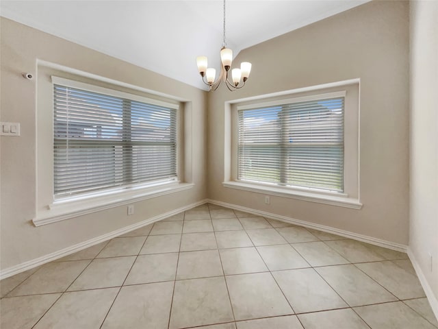 empty room with a chandelier and light tile floors