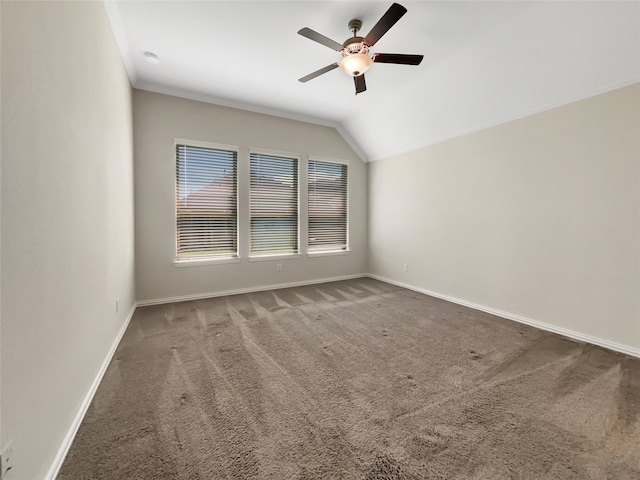 spare room featuring lofted ceiling, ceiling fan, and carpet