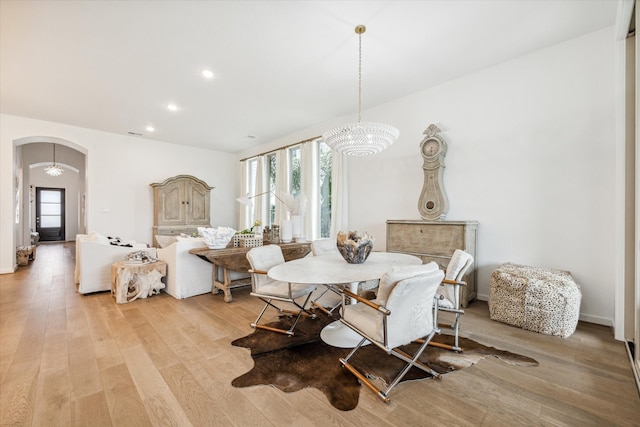 dining space with a chandelier and light wood-type flooring