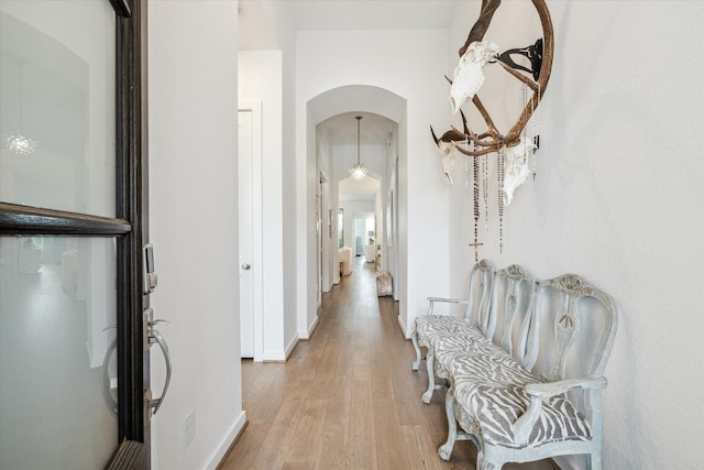 hallway with light hardwood / wood-style floors