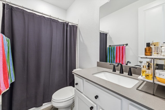 bathroom with toilet and large vanity