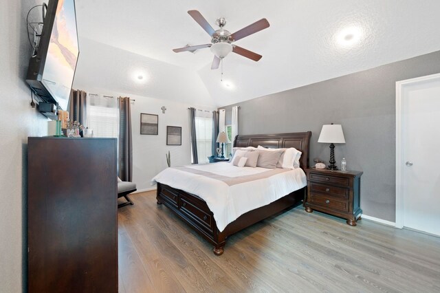 bedroom with lofted ceiling, ceiling fan, and hardwood / wood-style floors