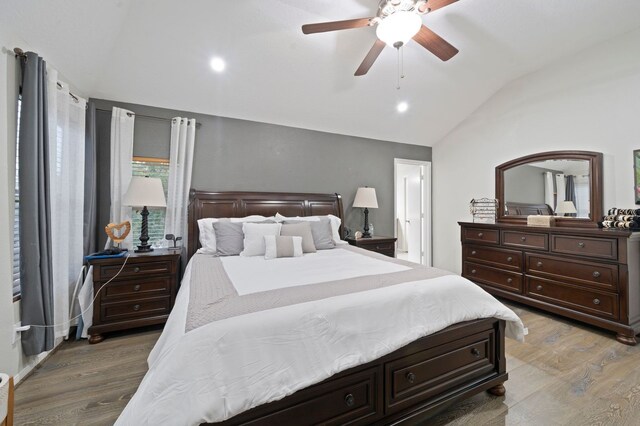 bedroom with wood-type flooring, ceiling fan, and vaulted ceiling