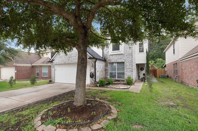 view of front of property featuring a garage and a front lawn