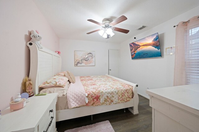 bedroom with ceiling fan and dark hardwood / wood-style flooring