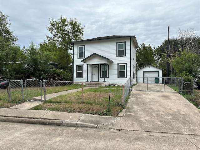 view of front of home featuring a garage, a front lawn, and an outdoor structure