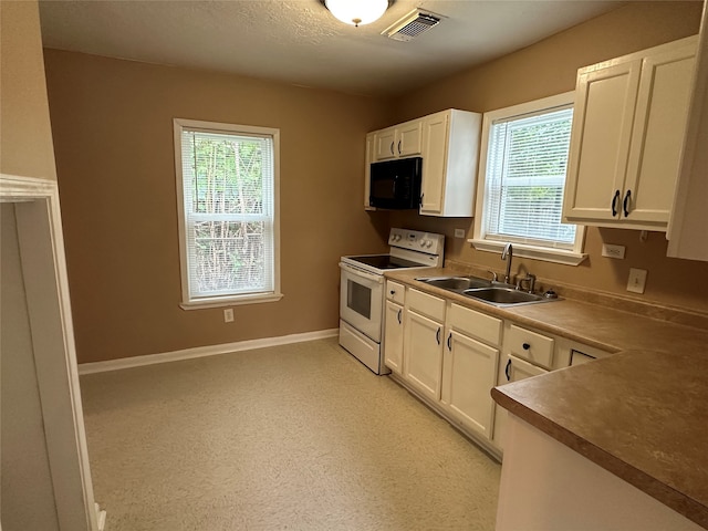 kitchen with white cabinets, light carpet, white range with electric stovetop, and sink