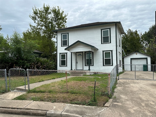 view of front facade featuring an outdoor structure, a front yard, and a garage