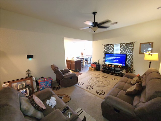 carpeted living room with ceiling fan