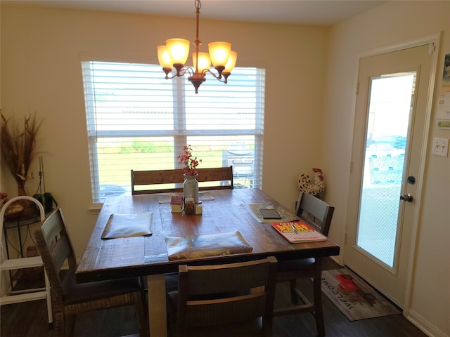 dining area featuring wood-type flooring, plenty of natural light, and a chandelier