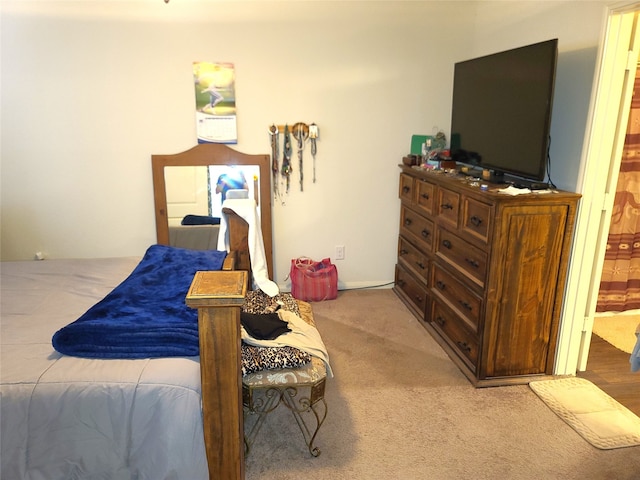 bedroom with connected bathroom and carpet flooring