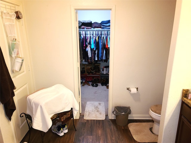 bathroom with vanity, hardwood / wood-style flooring, and toilet