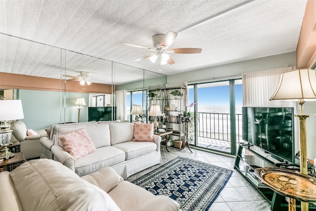 living room featuring a textured ceiling, ceiling fan, and light tile floors