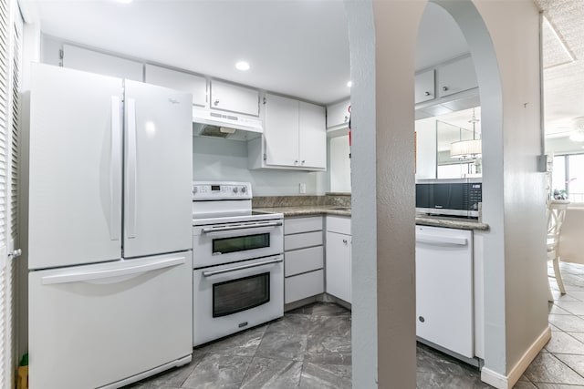 kitchen with tile floors and white appliances