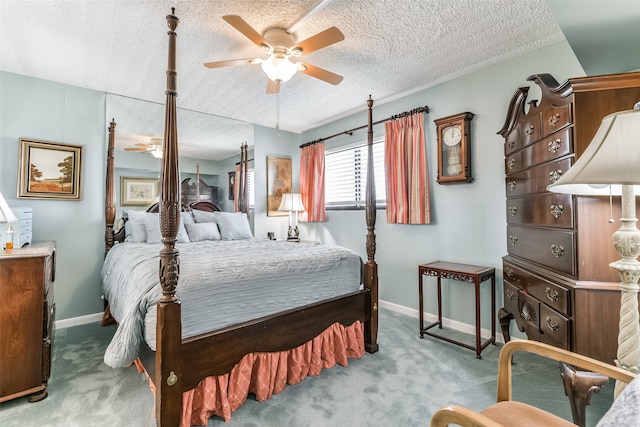 bedroom with a textured ceiling, carpet floors, and ceiling fan