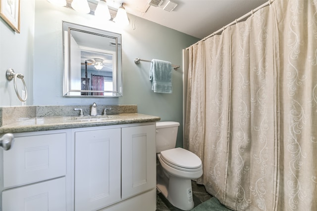 bathroom with tile flooring, vanity, and toilet