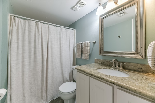 bathroom featuring toilet and large vanity