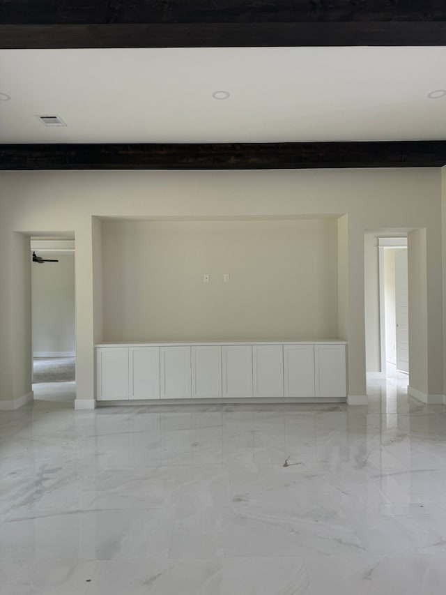 spare room featuring beam ceiling