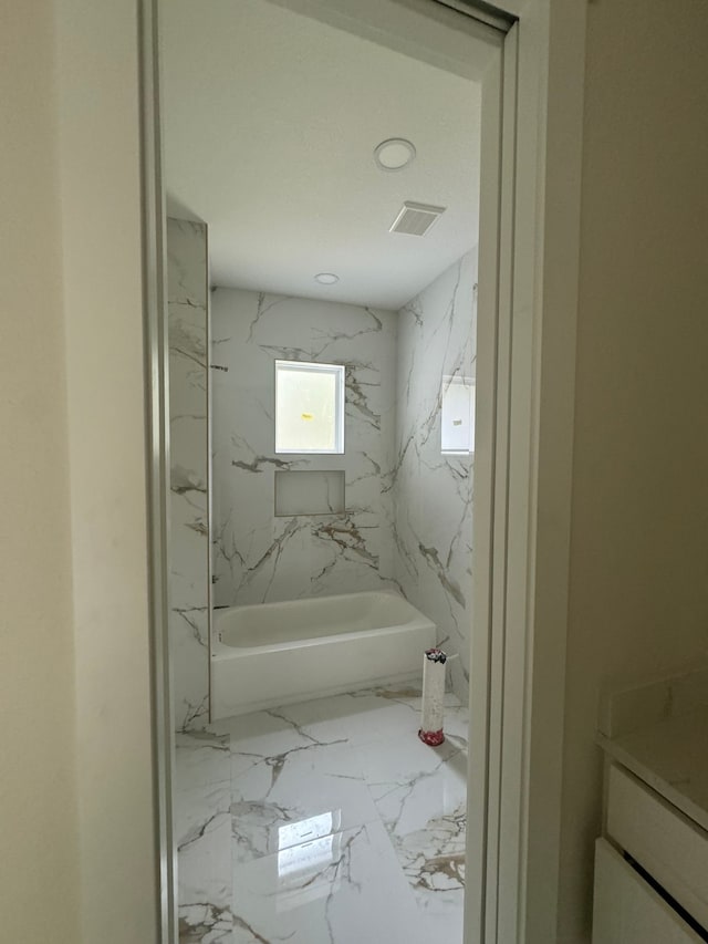 bathroom with vanity and bathing tub / shower combination