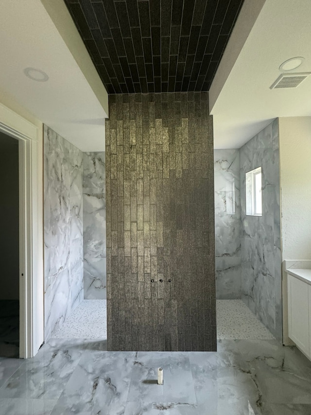 bathroom featuring vanity and a tile shower