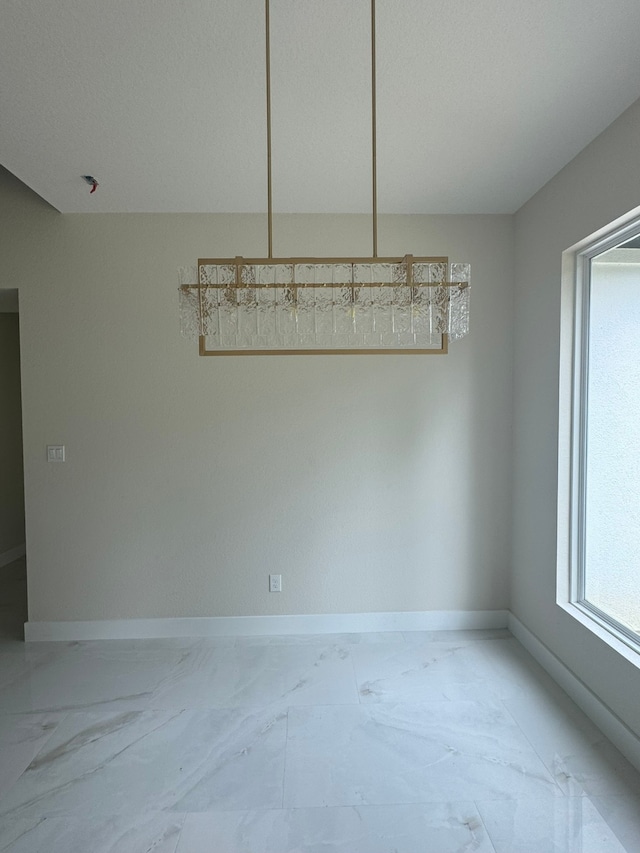 unfurnished dining area with a textured ceiling