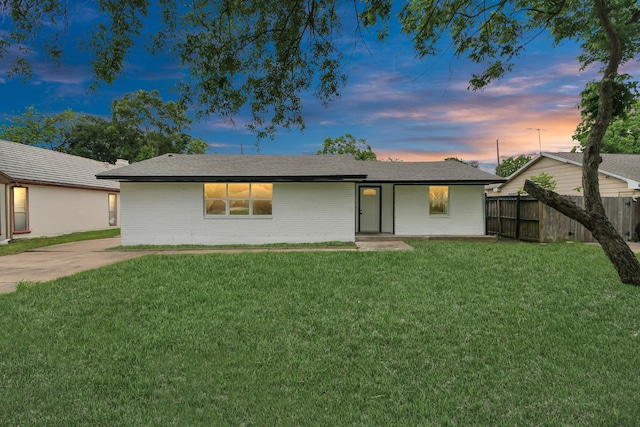 ranch-style home with a yard