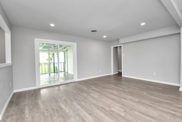 empty room with hardwood / wood-style flooring