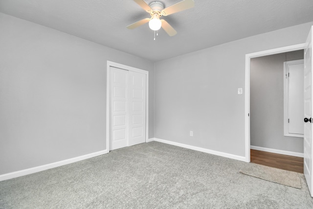 unfurnished bedroom with a closet, carpet floors, and ceiling fan