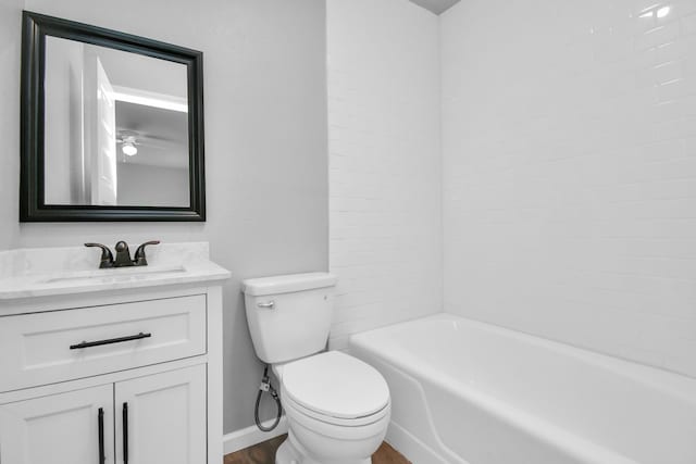 full bathroom with toilet, hardwood / wood-style floors, vanity, and tiled shower / bath combo