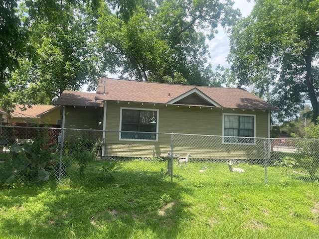 back of property with a lawn