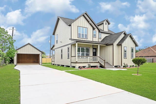 view of front of house with a porch, an outdoor structure, a garage, and a front lawn