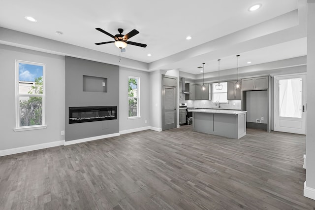 kitchen featuring a center island, plenty of natural light, ceiling fan, and hardwood / wood-style floors