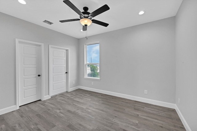 unfurnished room with wood-type flooring and ceiling fan