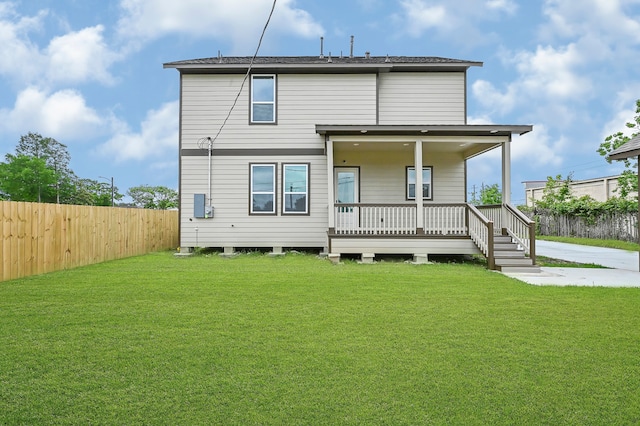 back of house with a lawn