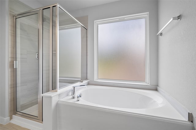 full bathroom with a garden tub and a shower stall