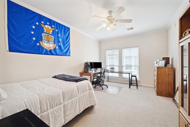 bedroom with ornamental molding, carpet, and ceiling fan