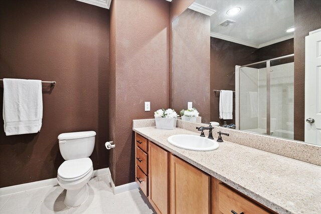 bathroom featuring ornamental molding, toilet, tile floors, and vanity with extensive cabinet space