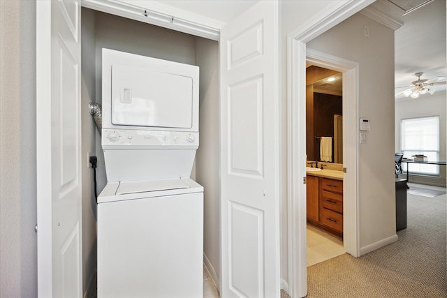 washroom with light carpet, ceiling fan, electric dryer hookup, and stacked washer and dryer