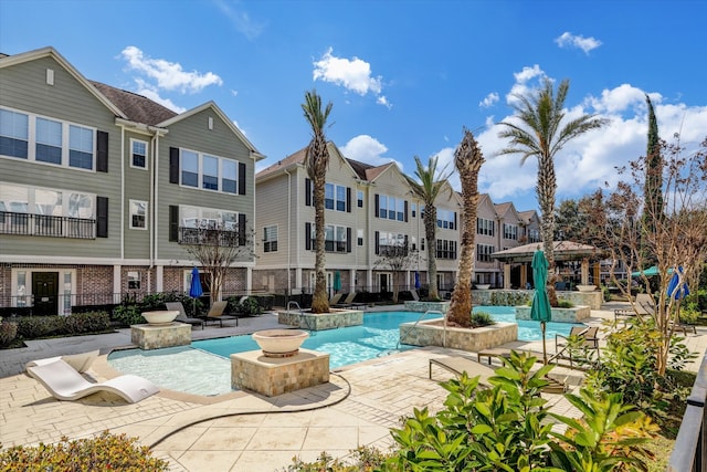 view of pool with a patio area and pool water feature